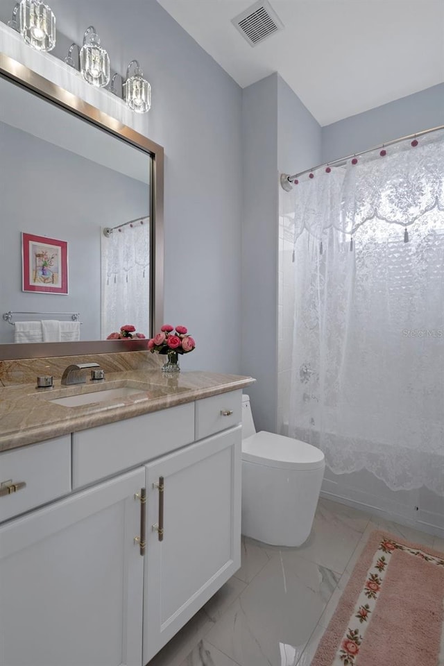 15630 N Himes Ave, Tampa, FL 33618 - full bathroom with marble finish floor, toilet, vanity, and visible vents