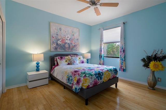 15630 N Himes Ave, Tampa, FL 33618 - bedroom with wood finished floors, a ceiling fan, and baseboards