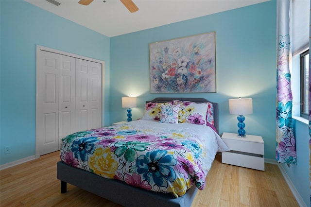 15630 N Himes Ave, Tampa, FL 33618 - bedroom featuring wood finished floors, a closet, baseboards, and ceiling fan
