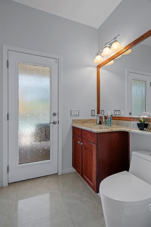 15630 N Himes Ave, Tampa, FL 33618 - bathroom with tile patterned flooring, toilet, vanity, and baseboards