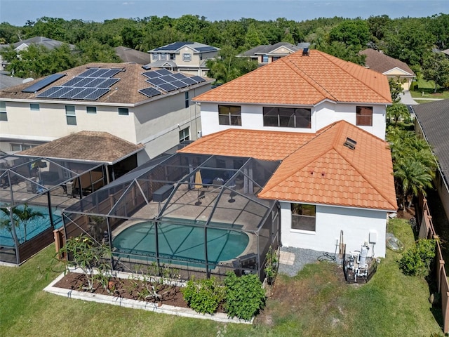 15630 N Himes Ave, Tampa, FL 33618 - back of property with glass enclosure, a fenced backyard, a tiled roof, and stucco siding