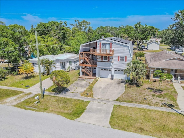 view of front of property featuring driveway, stairway, a front yard, and a garage