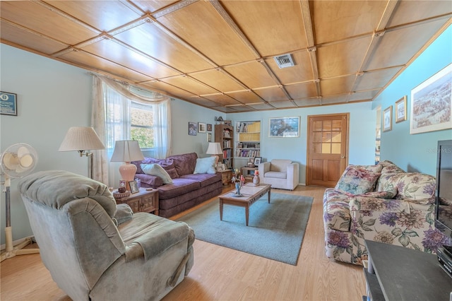 living area with visible vents and wood finished floors