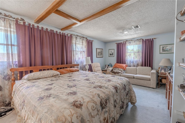 bedroom featuring a textured ceiling, visible vents, beam ceiling, and light colored carpet