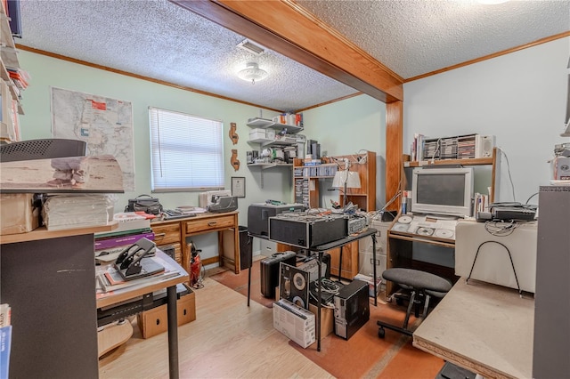 office featuring crown molding, a textured ceiling, visible vents, and wood finished floors