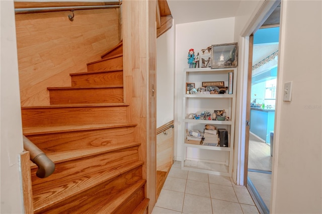 stairway featuring tile patterned flooring