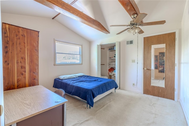 bedroom with vaulted ceiling with beams, a ceiling fan, a walk in closet, visible vents, and carpet floors