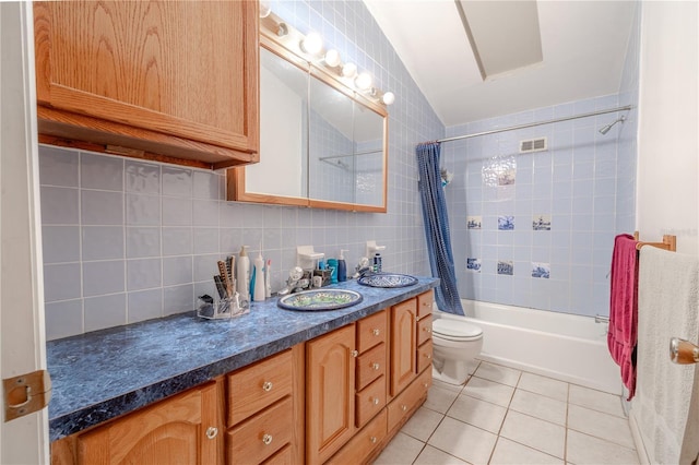 bathroom with tasteful backsplash, shower / bath combo with shower curtain, toilet, tile patterned floors, and vanity