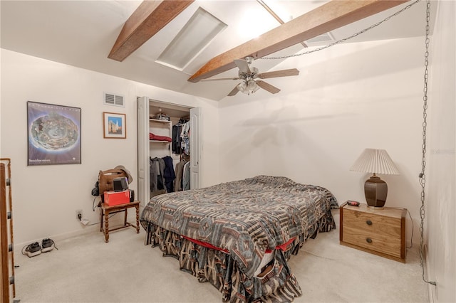 bedroom with lofted ceiling with beams, a closet, carpet, a walk in closet, and visible vents