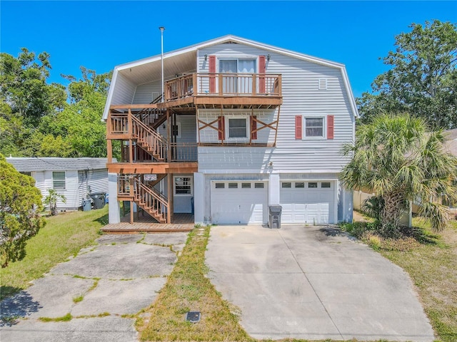 view of front of property with concrete driveway, stairway, and a garage