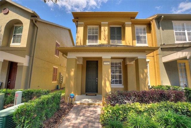 view of front of house featuring stucco siding and covered porch