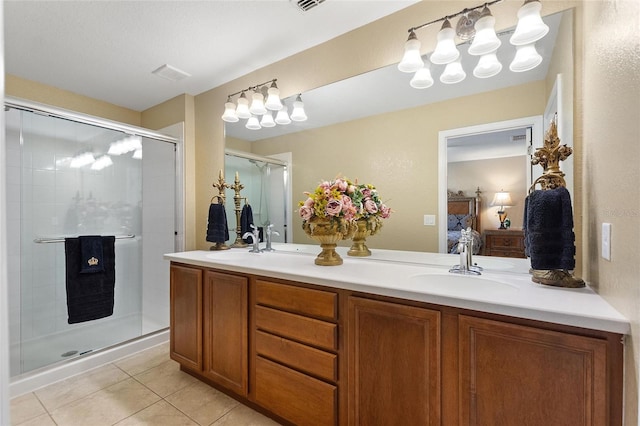 full bathroom featuring a shower stall, tile patterned floors, a sink, double vanity, and ensuite bath
