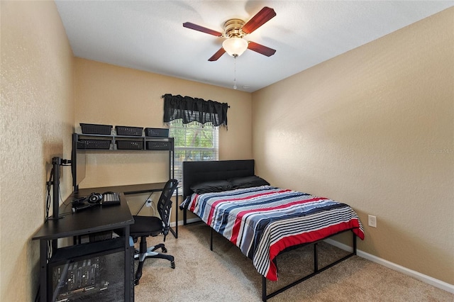 bedroom featuring a textured wall, baseboards, and carpet flooring