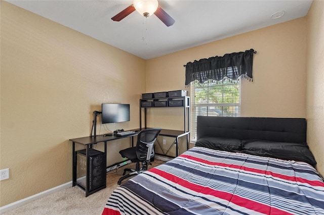 carpeted bedroom with a ceiling fan and baseboards