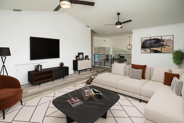 living area with a ceiling fan, light wood-type flooring, lofted ceiling, and crown molding