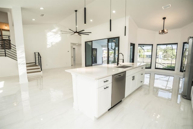 kitchen featuring stainless steel appliances, a sink, white cabinetry, high vaulted ceiling, and a kitchen island with sink