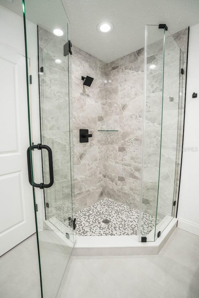 full bath with a stall shower and recessed lighting
