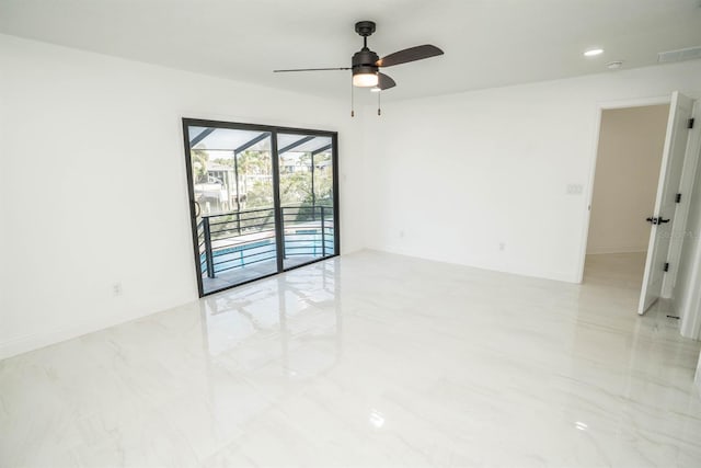 unfurnished room with ceiling fan, baseboards, marble finish flooring, and a sunroom
