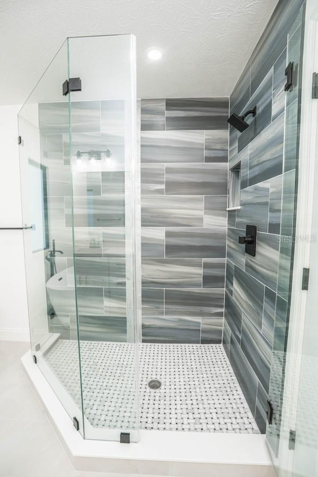 full bathroom featuring a stall shower and recessed lighting