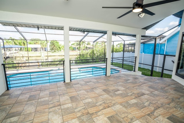 outdoor pool featuring ceiling fan, glass enclosure, and a patio