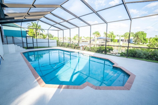 swimming pool featuring a patio area and glass enclosure