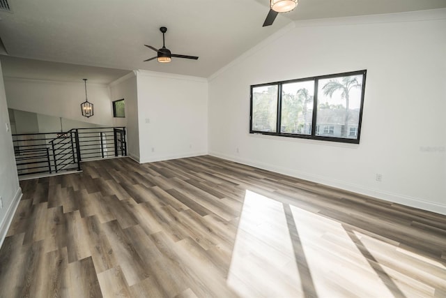 unfurnished living room featuring ceiling fan, wood finished floors, baseboards, and lofted ceiling