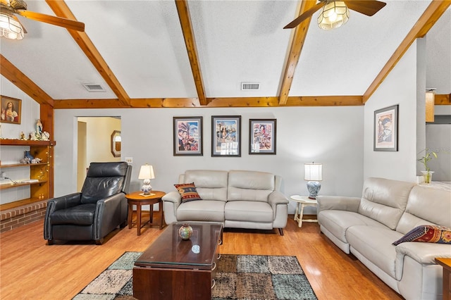 living room featuring vaulted ceiling with beams, a ceiling fan, wood finished floors, and visible vents