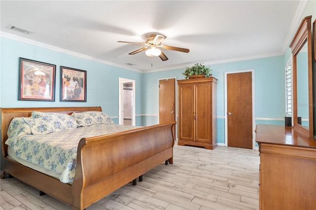 bedroom with crown molding, visible vents, and light wood finished floors