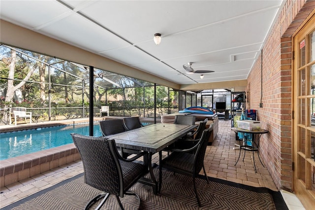 sunroom featuring outdoor dining area and ceiling fan