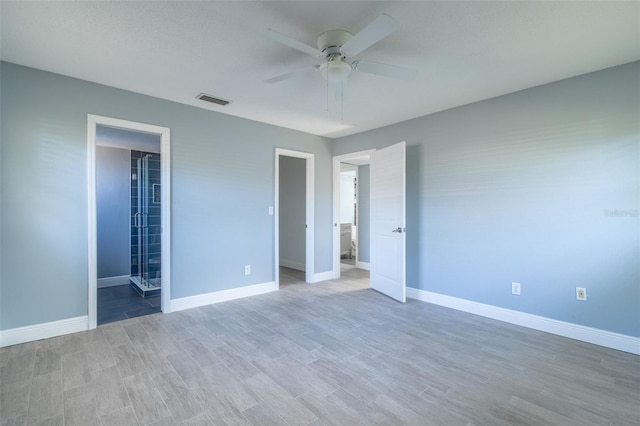unfurnished bedroom featuring baseboards, visible vents, and light wood-style floors