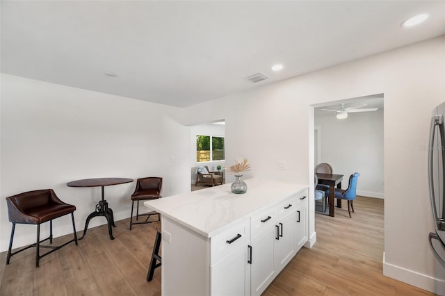 1401 49th St N, Saint Petersburg, FL 33710 - kitchen with baseboards, white cabinets, light wood-style floors, a ceiling fan, and recessed lighting
