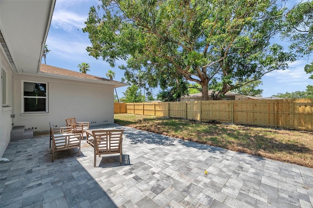 1401 49th St N, Saint Petersburg, FL 33710 - view of patio with a fenced backyard and an outdoor living space