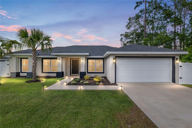6873 SW 131st Pl, Ocala, FL 34473 - ranch-style home featuring roof with shingles, an attached garage, stucco siding, concrete driveway, and a yard