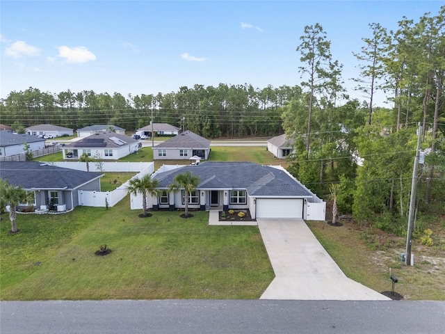 6873 SW 131st Pl, Ocala, FL 34473 - view of front facade with concrete driveway, an attached garage, fence, and a front yard