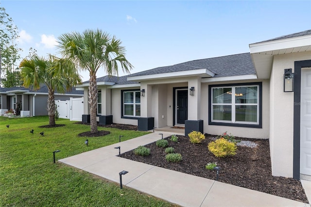 6873 SW 131st Pl, Ocala, FL 34473 - view of front of house featuring roof with shingles, central AC, a front yard, and stucco siding