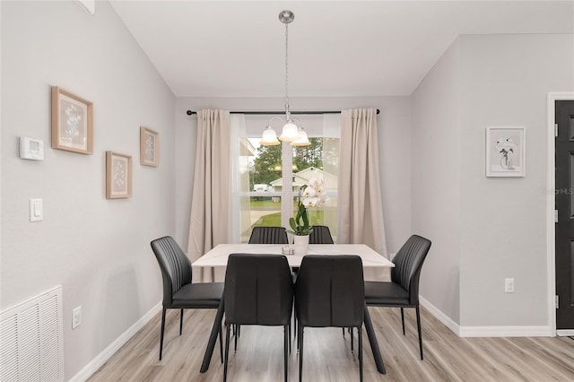 6873 SW 131st Pl, Ocala, FL 34473 - dining space featuring visible vents, light wood finished floors, baseboards, and a notable chandelier