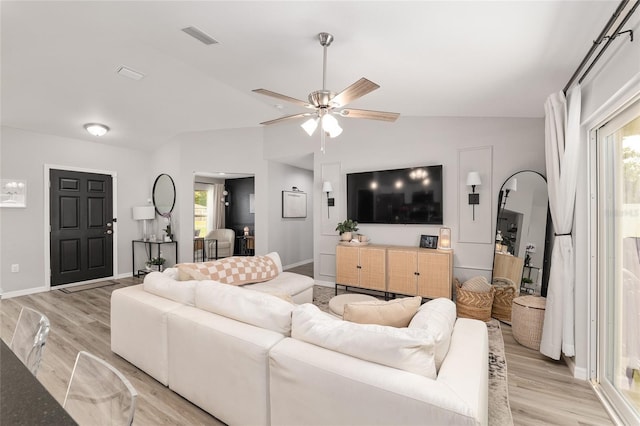 6873 SW 131st Pl, Ocala, FL 34473 - living room with visible vents, light wood-style floors, baseboards, ceiling fan, and vaulted ceiling