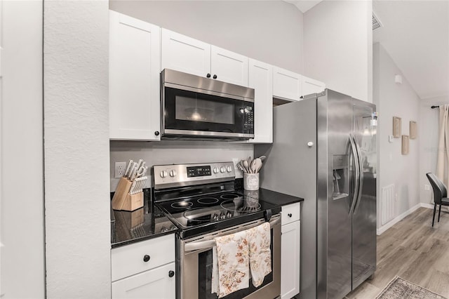 6873 SW 131st Pl, Ocala, FL 34473 - kitchen featuring light wood-style floors, baseboards, appliances with stainless steel finishes, and white cabinets