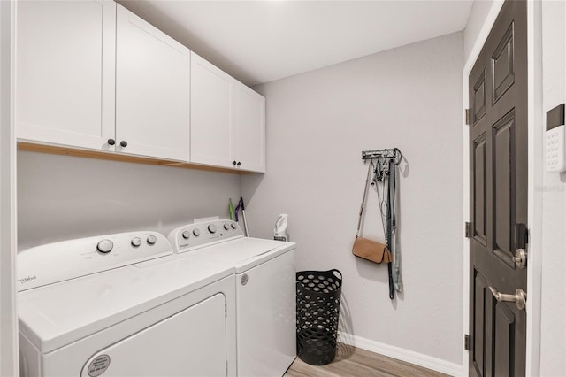 6873 SW 131st Pl, Ocala, FL 34473 - clothes washing area featuring cabinet space, baseboards, wood finished floors, and washer and dryer