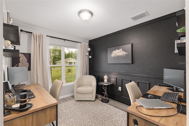 6873 SW 131st Pl, Ocala, FL 34473 - office area featuring a textured ceiling, wood finished floors, and visible vents