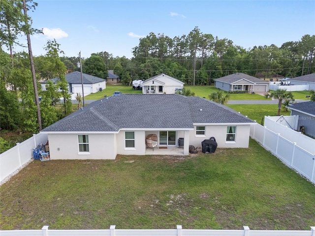 6873 SW 131st Pl, Ocala, FL 34473 - rear view of property with roof with shingles, stucco siding, a fenced backyard, a patio area, and a yard