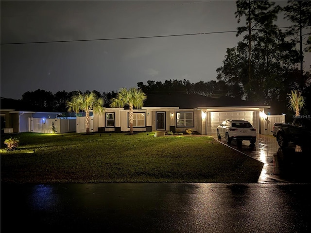6873 SW 131st Pl, Ocala, FL 34473 - view of front of home with an attached garage, a yard, and concrete driveway