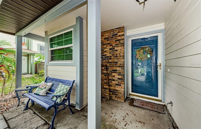 678 Greenglen Ln, Palm Harbor, FL 34684 - doorway to property with a porch and brick siding