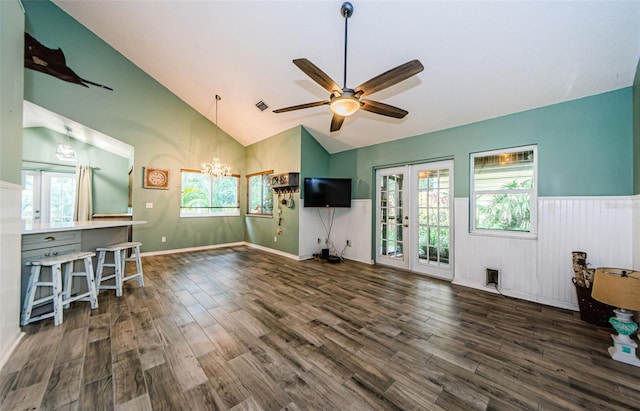 678 Greenglen Ln, Palm Harbor, FL 34684 - living room featuring wood finished floors, ceiling fan, a chandelier, plenty of natural light, and wainscoting