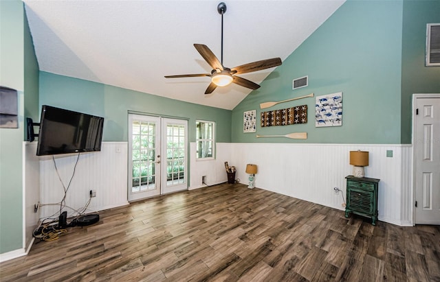 678 Greenglen Ln, Palm Harbor, FL 34684 - unfurnished living room with wainscoting, wood finished floors, french doors, a ceiling fan, and high vaulted ceiling