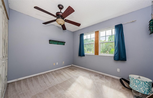 678 Greenglen Ln, Palm Harbor, FL 34684 - carpeted spare room featuring baseboards, a ceiling fan, and a textured ceiling