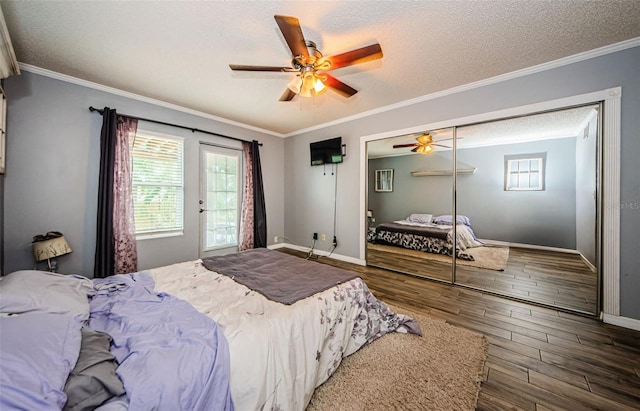 678 Greenglen Ln, Palm Harbor, FL 34684 - bedroom featuring a textured ceiling, multiple windows, baseboards, wood finished floors, and a ceiling fan