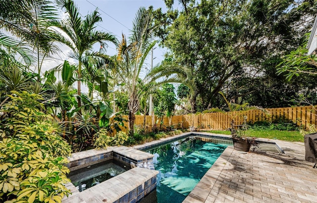 678 Greenglen Ln, Palm Harbor, FL 34684 - view of swimming pool featuring an in-ground hot tub, a fenced backyard, and a patio