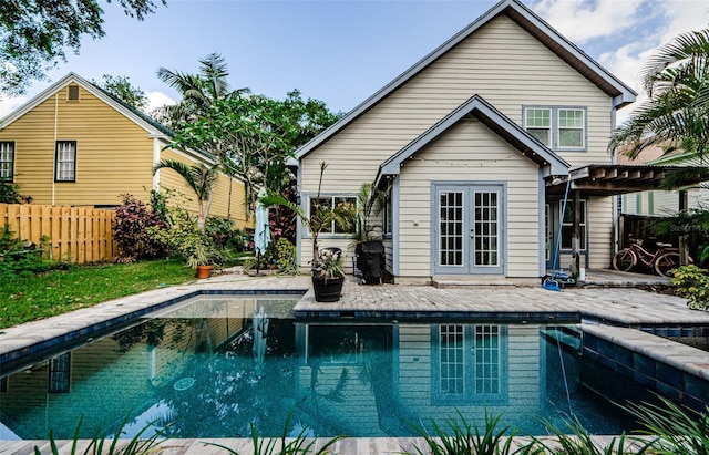 678 Greenglen Ln, Palm Harbor, FL 34684 - swimming pool with french doors, a patio area, and a pergola