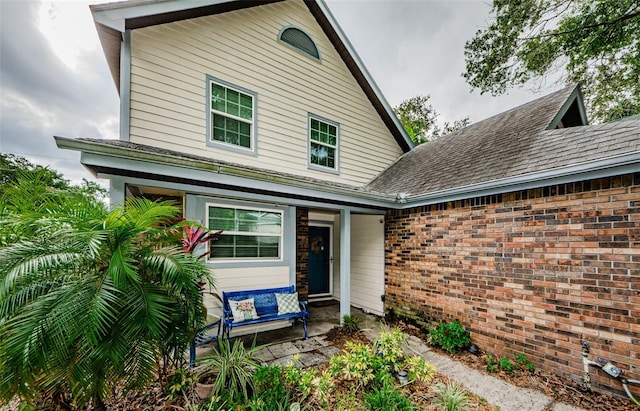 678 Greenglen Ln, Palm Harbor, FL 34684 - view of front of house featuring roof with shingles and brick siding